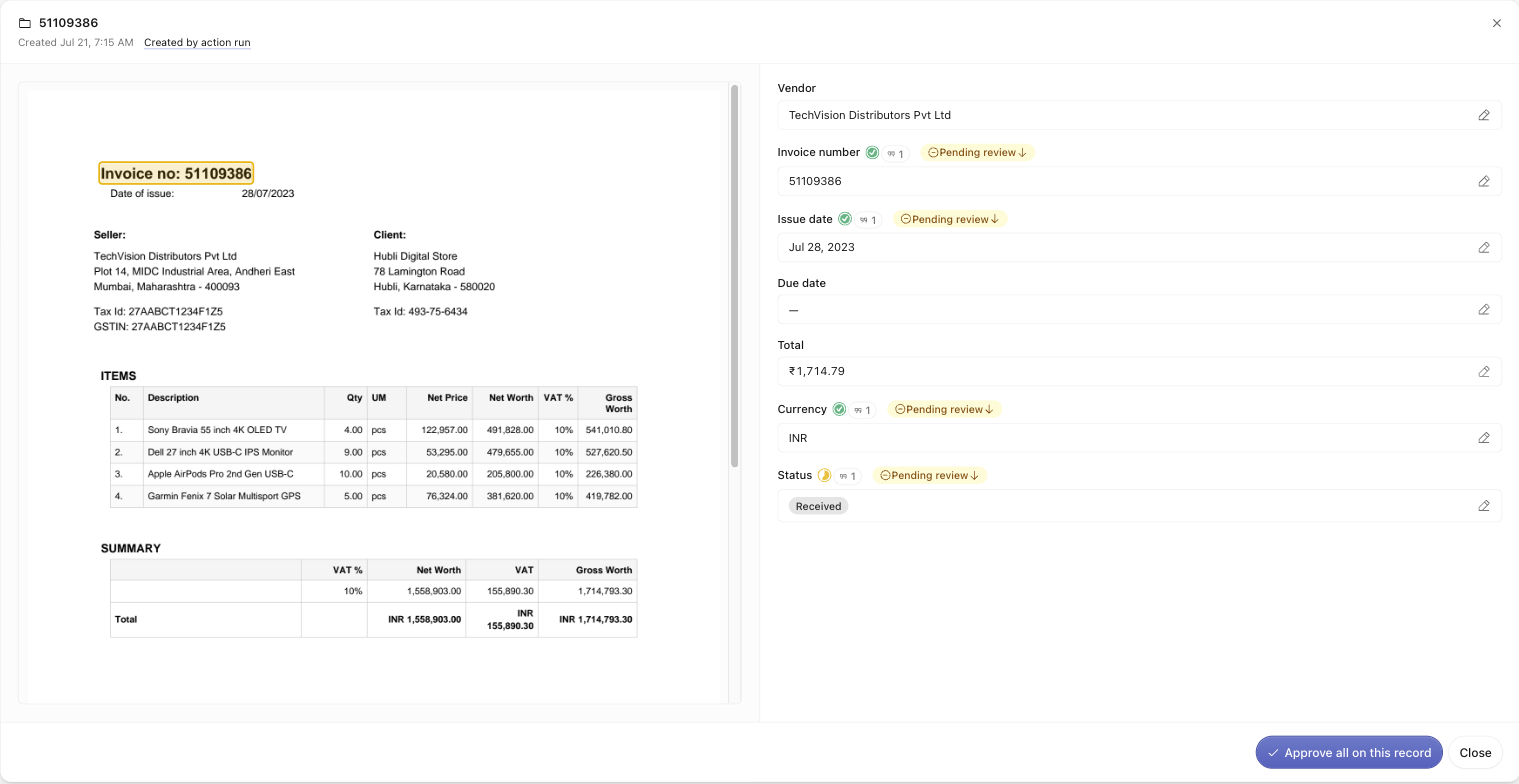 A record open as a two-pane workspace: the cited source invoice with a highlighted invoice number on the left, and the fields with their citation and review chips on the right